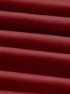 Close-up macro view showing the soft texture of dark red knitted fabric for men's polo shirt.