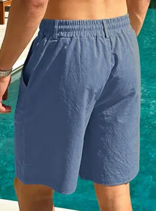 Back view of men's breathable blue cotton linen casual shorts worn at a summer swimming pool