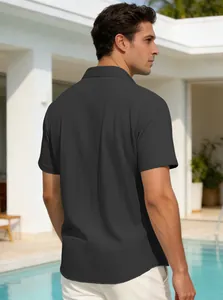 Back view of a men's dark grey short-sleeved polo shirt with waffle texture detail