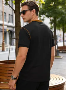 Back view of a casual black men's polo shirt with brown contrast trim detailing