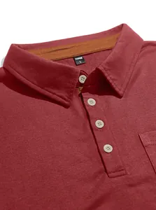 Close-up detail of burgundy men's polo shirt with white buttons and collar.