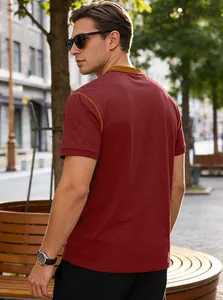 Rear view of a men's casual dark red polo shirt showcased in a stylish city street setting