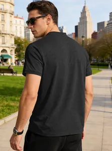 Back view of a breathable black short-sleeve polo shirt for men in a scenic city park.