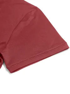 Close-up of double-stitched hem on a maroon men's short sleeve business casual polo shirt
