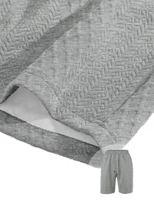Detailed macro view of premium grey jacquard textured fabric on men's athletic shorts