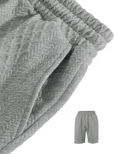 Close-up detail of textured jacquard fabric and side pocket on grey men's casual shorts