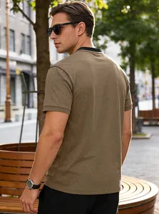 Detailed back view of a men's casual brown short-sleeved polo shirt in an outdoor setting.