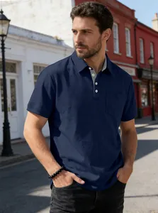 Close-up of a navy blue men's polo shirt featuring a functional pocket and buttoned collar.