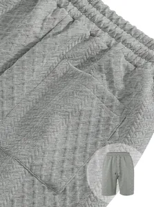 Detailed macro view of grey textured jacquard knit shorts with elastic waistband and pocket