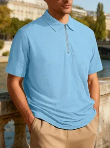 High-quality detail of light blue jacquard polo shirt with a stylish zipper neckline.