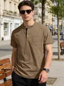 Detailed view of men's casual khaki Henley shirt with chest pocket in city street