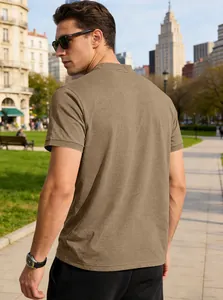 Back view of a man wearing a breathable brown Henley short sleeve shirt in a park setting.