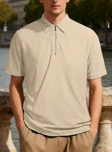 Detailed view of a men's beige quarter-zip polo shirt featuring textured jacquard fabric