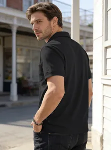 Back view of a man wearing a black business casual short-sleeve Polo shirt with pocket