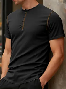 Close-up of black waffle knit Henley shirt with contrast stitching and button placket