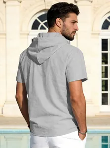 Back view of a breathable grey cotton linen hooded T-shirt worn by a male model outdoors.