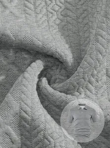 Detailed macro shot of premium grey jacquard fabric texture for men's polo shirt set