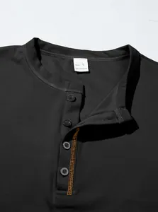 Close-up of black men's Polo shirt featuring pineapple grid texture and button placket