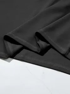 Close-up of charcoal grey polo shirt hem showing waffle weave texture and stitching