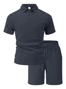 Detail showing the intricate diamond jacquard texture on this navy blue men's polo set.