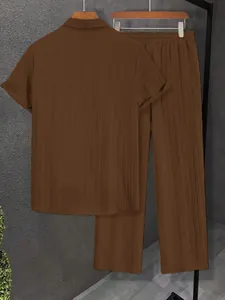 Back view of brown pleated short sleeve shirt and matching long pants set for men
