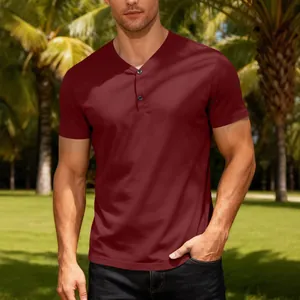Men's burgundy V-neck Henley short sleeve t-shirt in a tropical outdoor setting