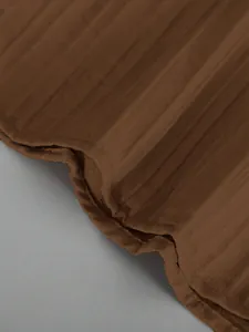 Detailed close-up of brown textured fabric for men's casual Hawaiian shirt and pants set