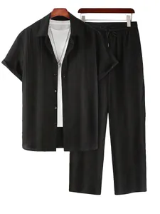 Detail view of black textured casual shirt and matching pants set on hangers