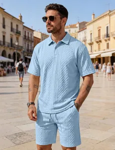 Detailed view of the textured light blue polo shirt and shorts set on a model outdoors.
