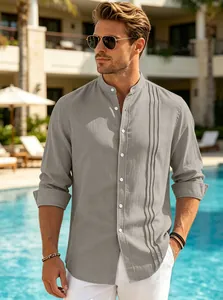 Men's stand collar linen-style shirt with pleated detail in a poolside resort setting.