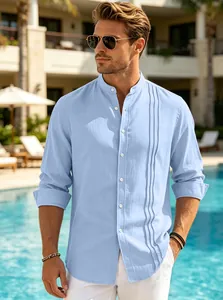 Men's light blue stand collar linen shirt with vertical pleated detail shown in resort setting