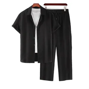 Men's black casual short-sleeve shirt and matching trousers set on white background