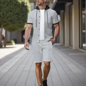 Male model wearing grey textured short sleeve hooded shirt and matching shorts for summer