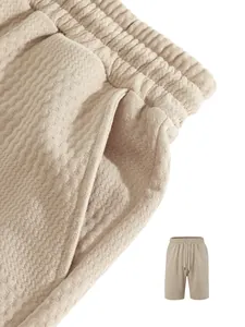 Close-up of beige men's jacquard shorts with textured fabric and elastic drawstring waist