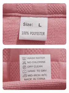 Detailed view of size and fabric care labels on a pink jacquard men's loungewear set.