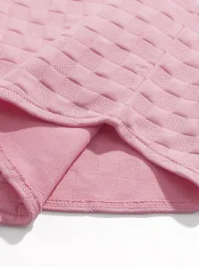 Macro view of breathable pink jacquard fabric with checkered texture for men's loungewear