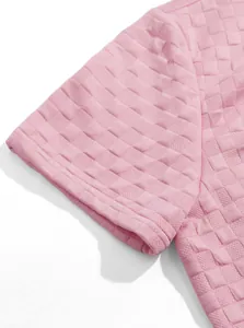 Close-up detail of the pink jacquard knit fabric texture on a men's short sleeve casual shirt