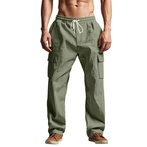 Detail view of loose fit men's linen cargo pants with drawstring and pockets