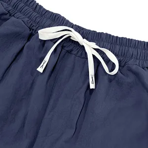 Detailed close-up of men's casual pants showing elastic waistband and white drawstring.