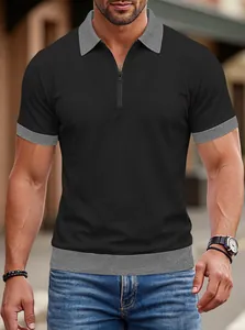 Détail d'un polo en maille noire pour homme avec col contrasté gris et demi-zip