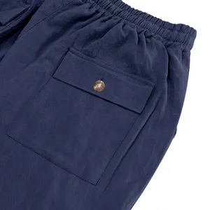 Close-up of navy blue pants featuring elastic waistband and buttoned cargo pocket