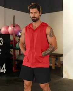Professional male athlete wearing a red sleeveless hooded fitness vest with zipper in a gym.