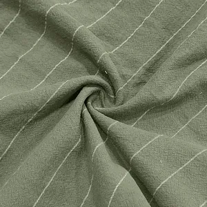 Macro detail of breathable olive green linen fabric featuring classic white vertical stripes