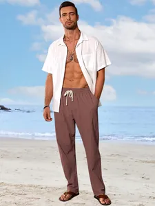 Men's loose breathable cotton linen pants styled on a sunny beach background.
