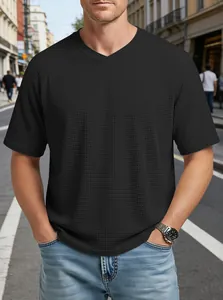 Detailed view of men's black waffle knit t-shirt featuring V-neck and raglan sleeve design