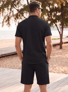 Back view of men's black jacquard short sleeve shirt and shorts set on a beach boardwalk