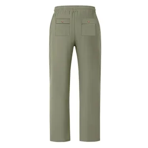 Back view of men's loose sage green breathable summer trousers with elastic waist and pockets