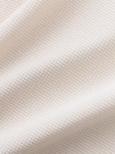 Macro shot of high-quality cream waffle knit fabric texture for men's casual T-shirt