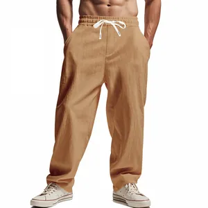 Detailed view of men's loose breathable camel wide-leg trousers with drawstring waist