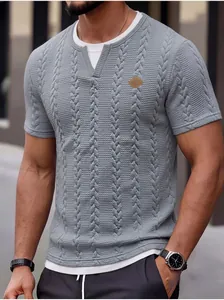 Detail showing the textured cable knit fabric and leather logo patch on a slim men's tee